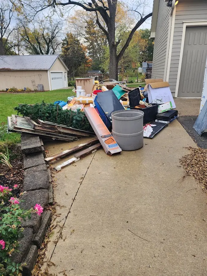 Dumpster being loaded with debris for Demolition Dumpster Rental in Mendon